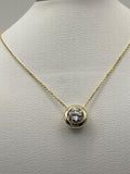 1 carat round brilliant solitaire bezel set solitaire in 14K solid yellow gold.