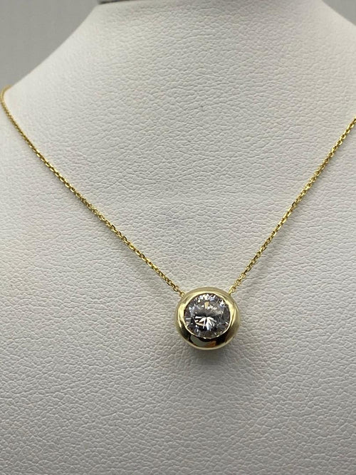 1 carat round brilliant solitaire bezel set solitaire in 14K solid yellow gold.